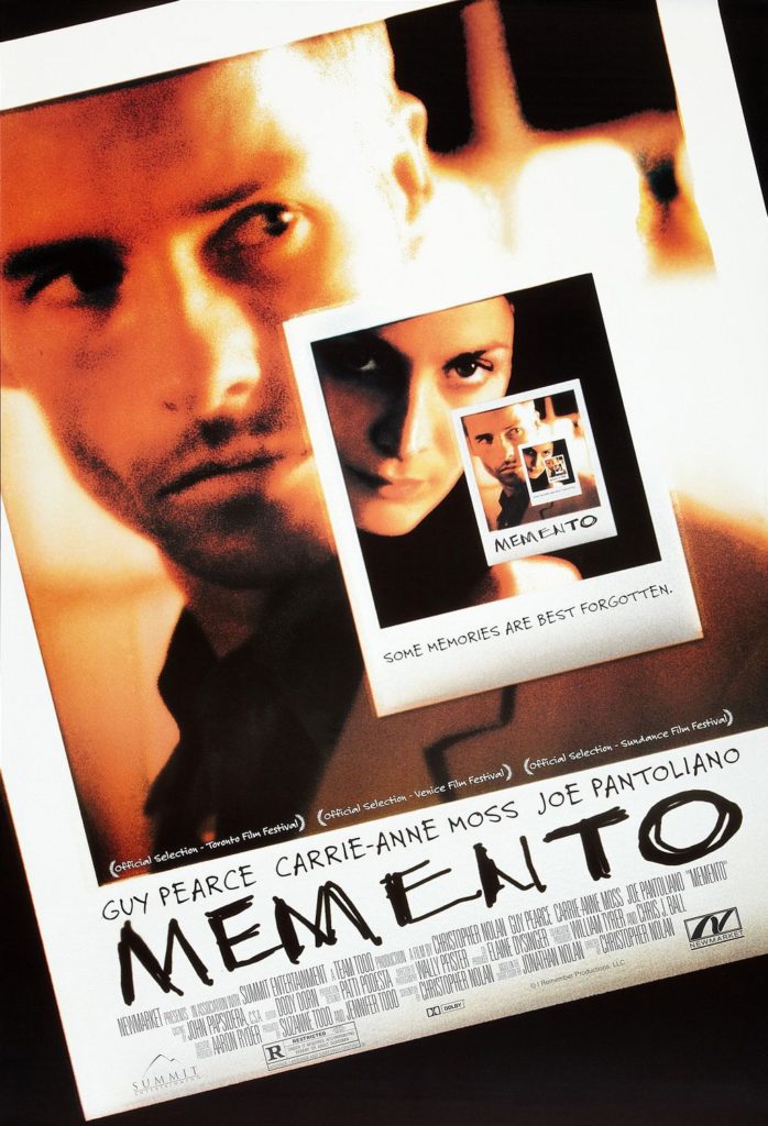 The movie poster for Memento, featuring a repeating series of instant film picture-within-pictures of a man and woman.